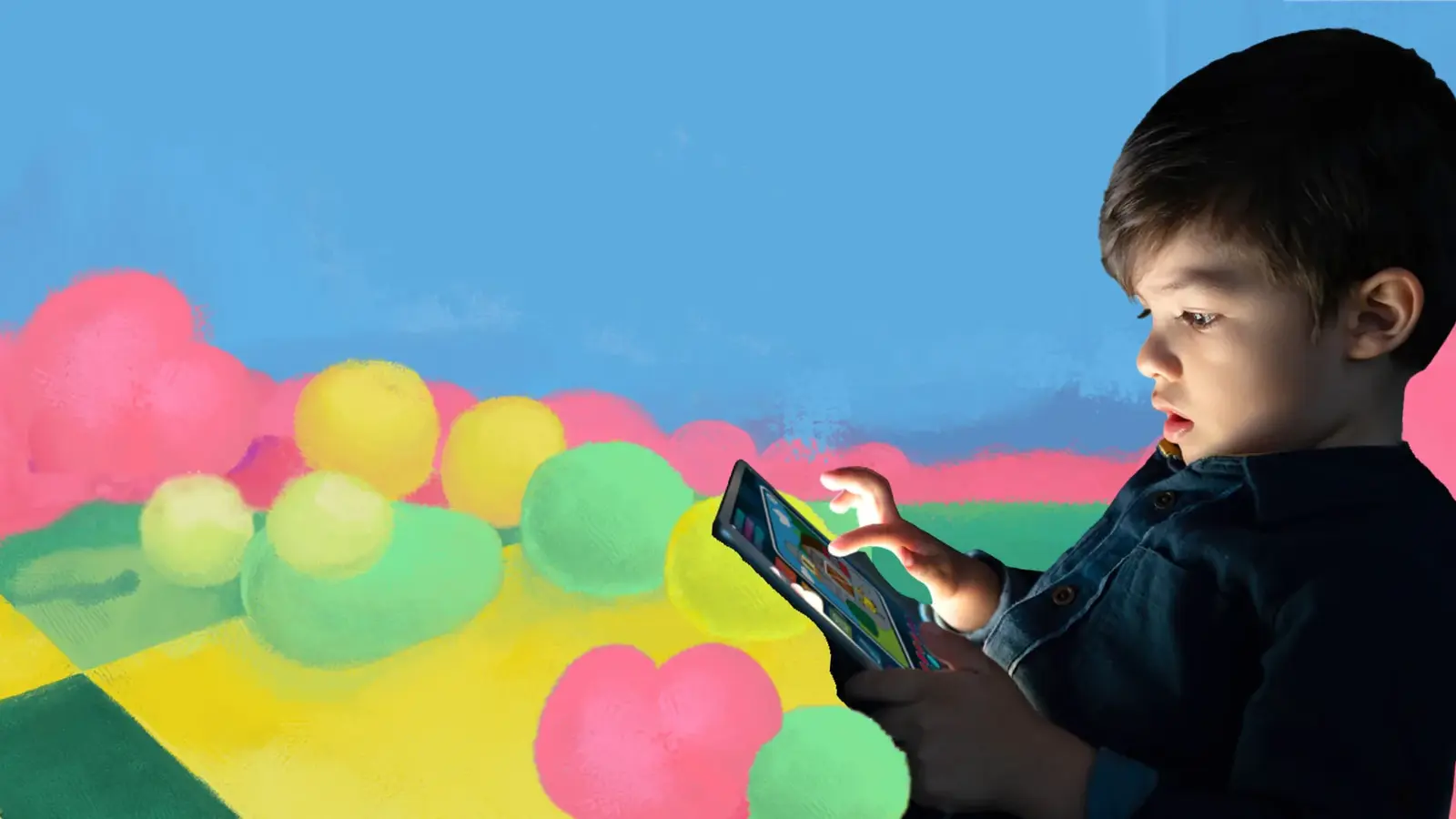 A young boy looking closely at a tablet as he taps the screen